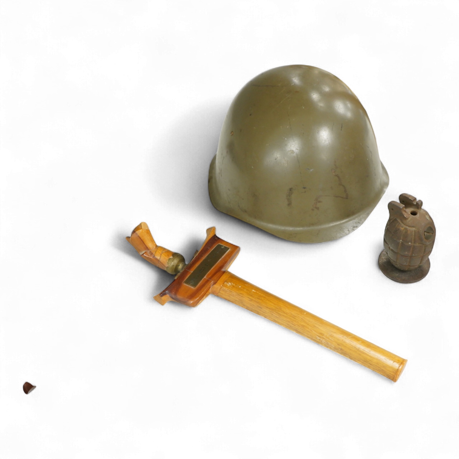 A Czech Vz53 tin helmet with liner, a Kris with applied presentation plaque engraved with ‘Presented by 'C' Battery’ and an inert British Mills hand grenade